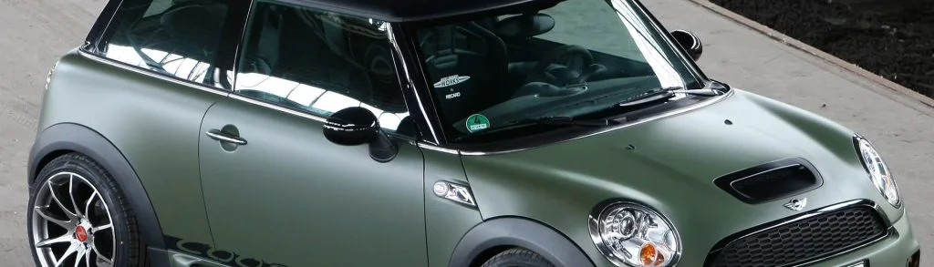 A mini Cooper in a Green wrap